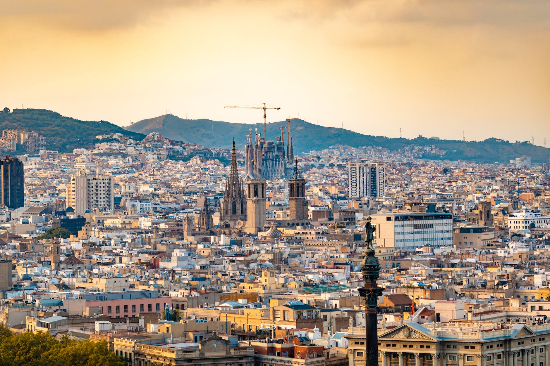 Barcelona cityscape at dusk with the sagrada família and surrounding architecture.
