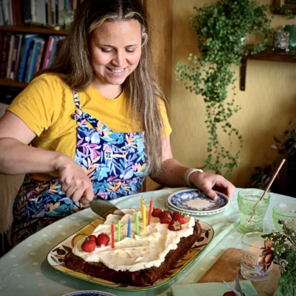 a woman is cutting a cake in front of a table.-Getting Closer to 40