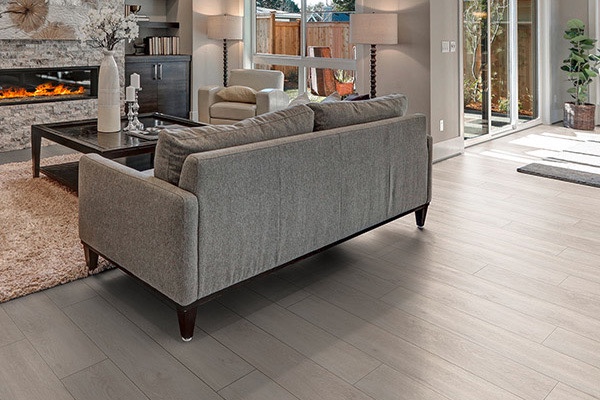 Luvanto vinyl flooring benefits-A living room with hardwood floors and a fireplace.