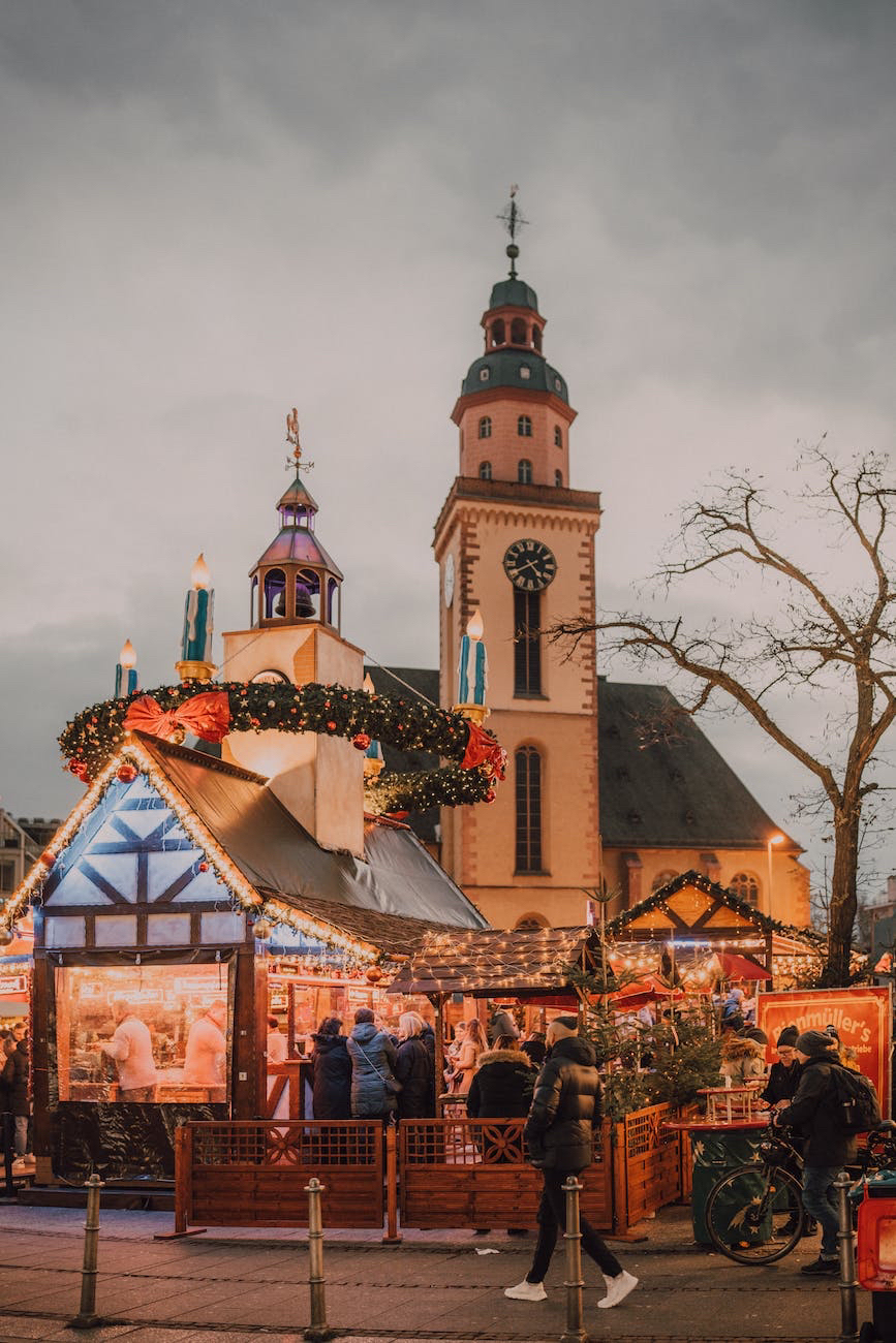 Norwegian Christmas Adventure-A christmas market in a city with a church in the background.