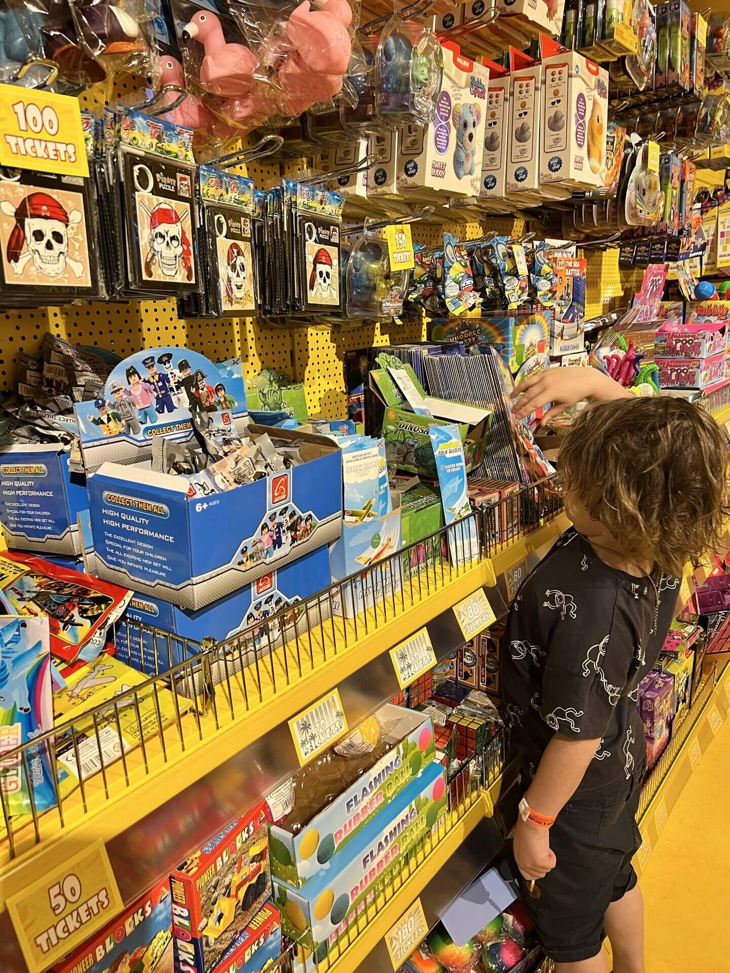 Boy choosing a prize in the amusement arcade at Devon Cliffs Haven