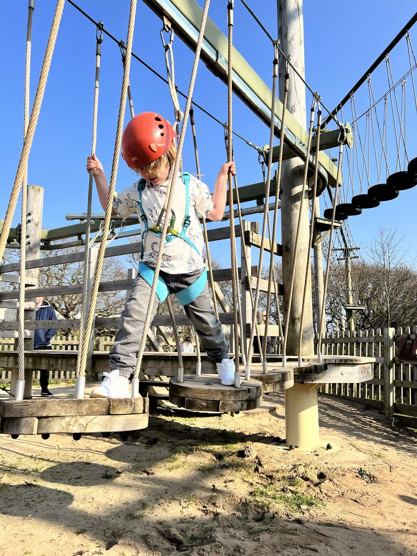 Boy crossing the high ropes course at Devon Cliffs Haven