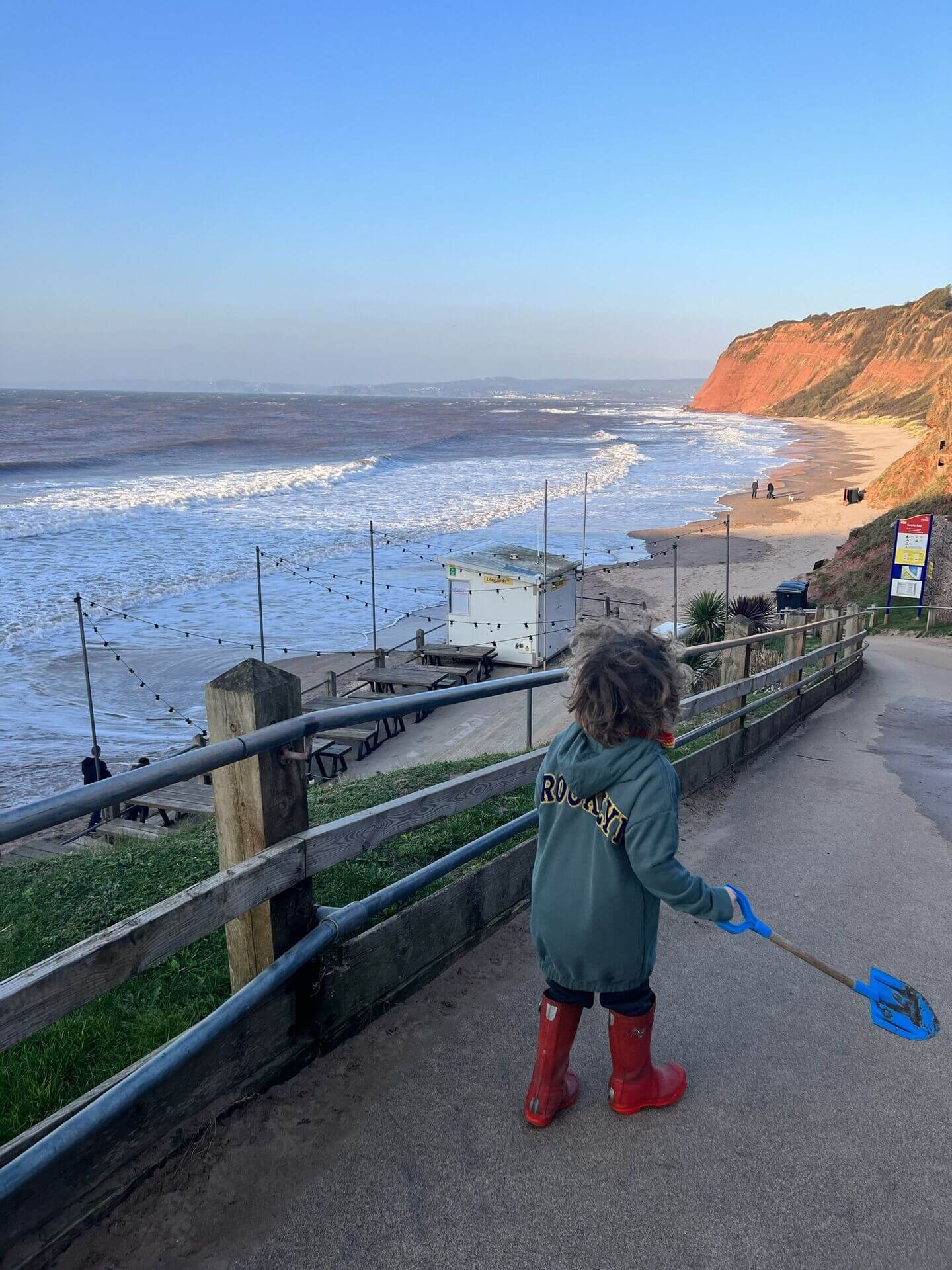 Looking down over Sandy Bay beach and the red cliffs at Devon Cliffs Haven